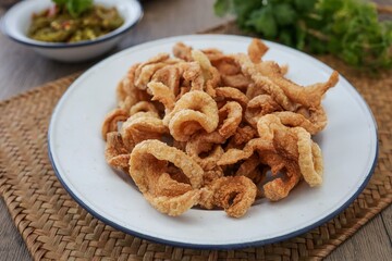 pork rind, pork cracking,pork snack, in white plate