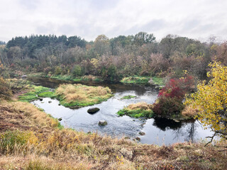Fototapeta premium Autumn view of the river and white wooden bridge, Murmuliu, Panevezys, Naujamiestis