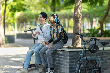 Young Adults Relaxing with Eco Transportation.