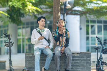 Young Adults Relaxing with Eco Transportation.