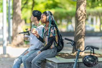 Young Adults Relaxing with Eco Transportation.