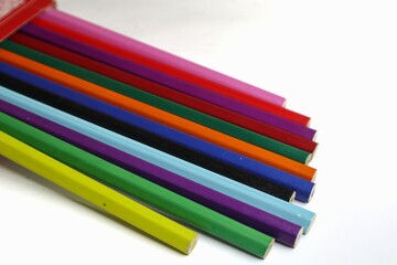 Fototapeta premium A box of colored pencils is shown against a white background.