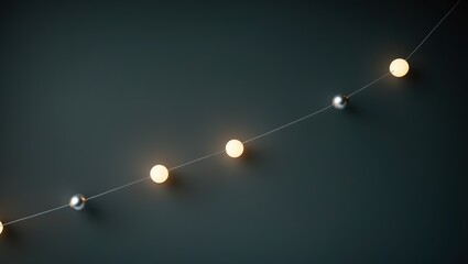 Obraz premium Soft glowing string lights with white and silver orbs against a dark, muted background, creating a cozy and inviting atmosphere.