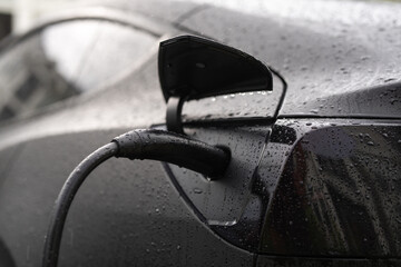 Electric car charging. Eco vehicle. Recharging battery for electric car. EV Electric car charging...