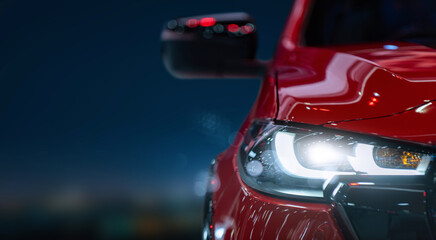 Generated imageClose-up view of a sleek red car's illuminated headlight with reflective details, captured at night against a blurred background.
