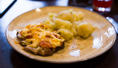 French meat with boiled potatoes served on plate