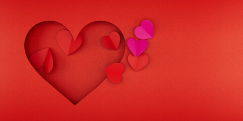 An eye-catching arrangement of red and pink paper hearts on a vibrant red backdrop, capturing the spirit of love and romance, ideal for Valentine's Day greetings or d�cor