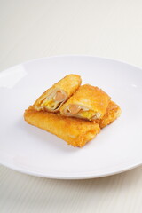 mayonnaise rissoles enclosed in crepe-like wrappers and rolled into bread crumbs and fried. served on wood plate. perfect for recipe, article, catalogue, promotion, or any cooking contents.