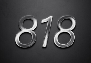 Chrome metal 3D number design of 818 on grey background.