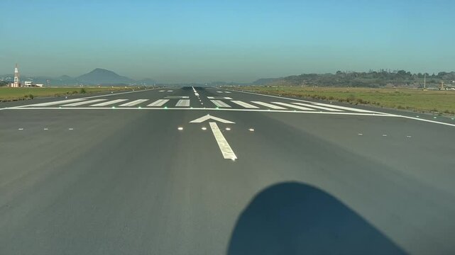 Exclusive view from the cockpit of the shadow of the nose of a jet starting the takeoff roll as seen by the pilots in a real tima takeoff from Valencia&rsquo;s airport, Spain.