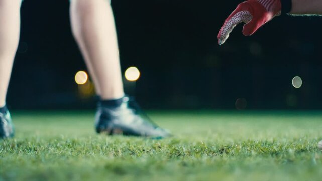 Cinematic shot of American Football player Kickoff Game Start. Static Close-up of Ball Being Kicked by the Professional Player. Gates Goal Kick. Successful Team Scores and Wins Championship.