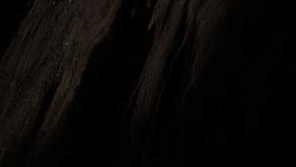Dark wood grain close-up with subtle texture.