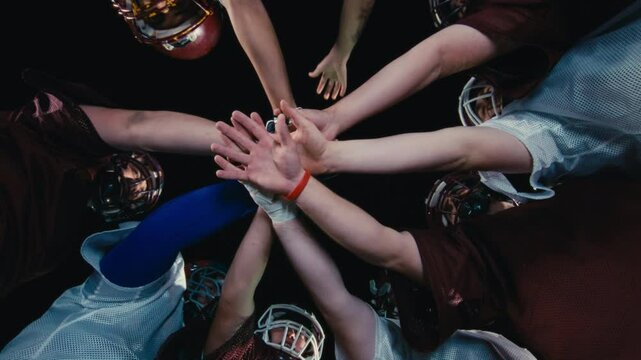American Football Players Joining Hands in circle Concept of United Team Spirit in Action