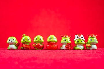 Chinese New Year of Snake mascots on red translation of the Chinese characters are attract wealth and treasures no logo no trademark
