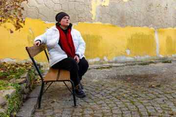 Fototapeta premium A plus-size woman strolling through the streets of a small European town.