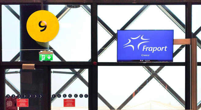 Photo of the Fraport Greece logo on a TV screen at Thessaloniki Airport. Fraport Greece manages 14 regional airports, enhancing travel and tourism in Greece.
