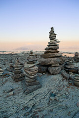 Balance pebble stone in the beach at sunset. Beautiful peaceful lake Garda, Italy. 