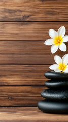 Fototapeta premium Relaxation self-care wellness. Serene stack of black stones with white flowers on a wooden background.