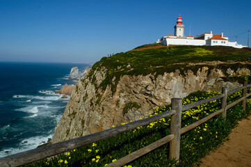 View of the Cabo da Roca Lighthouse. Sintra, Portugal. Portuguese Farol de Cabo da Roca is a cape which forms the westernmost point Eurasian land mass. 