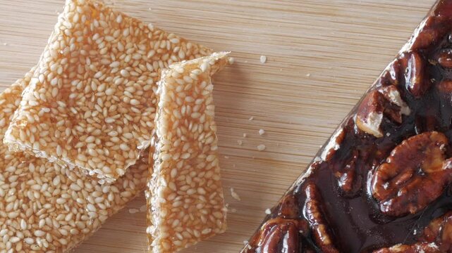 Pan view of almonds and sesame bars with honey