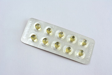 a pack of yellow pills isolated on the white background