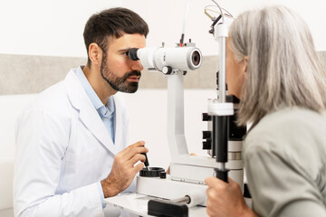 Ophthalmologist examining senior woman with slit lamp biomicroscope in clinic