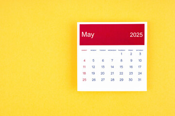 Calendar page May 2025 on yellow background.