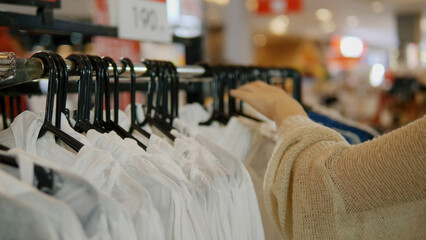 Shopping for clothes in a department store, clothes racks, travel and shopping