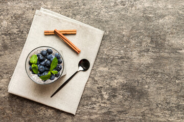 Healthy breakfast or morning with chia seeds vanilla pudding and blueberry berries on table background, vegetarian food, diet and health concept. Chia pudding with coconut milk and blueberry