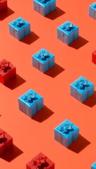 Obraz premium Pattern of Blue And Red Mini Gift Boxes On Bright Coral Background, Festive Holiday Concept.