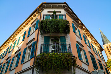 a romantic, quaint old house with overgrown with greenery balconies in the Austrian town of Bregenz...