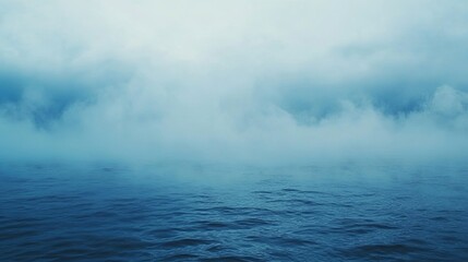 Fototapeta premium A gentle, soft mist gracefully coats the serene surface of the ocean during the tranquil early morning hours, close to a peaceful coastal area