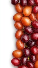 Obraz premium A bunch of red and orange grapes on a white surface