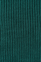 Green knitted wool jumper background texture, yarn surface