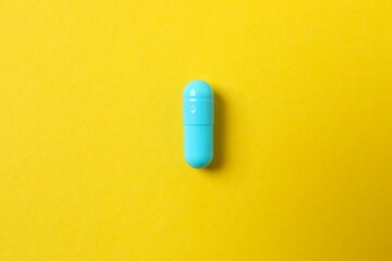Blue capsule on a colored background