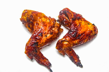 a piece of grilled chicken wings on a white background