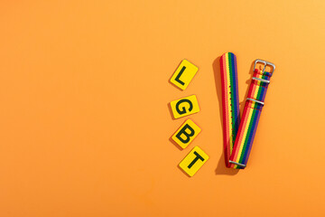 Colored lgbt bracelet on bright background.