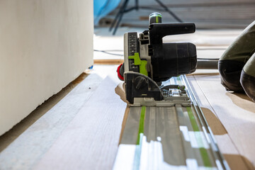 Close Up of Track Saw Cutting Wood Flooring on Guide Rail