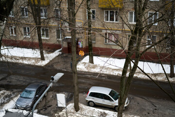 the last yellow leaf on the background of a winter courtyard in a Moscow residential area