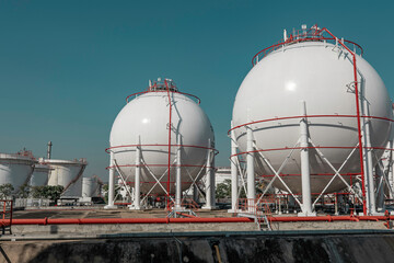 White spherical propane tanks containing fuel gas pipeline and scaffolding