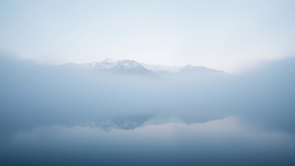 Naklejka premium Serene Misty Mountain Reflection in a Still Lake