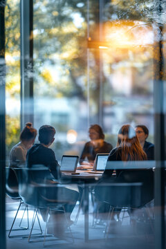 Defocused abstract background featuring a modern meeting room with natural light and a professional team collaborating. Ideal for business and corporate visuals.
