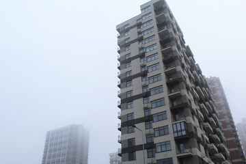 Fototapeta premium fog over new buildings in the city of Kyiv, Ukraine, modern apartment building in the city