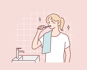 She is brushing her teeth in the bathroom. Hand drawn style vector design illustrations.