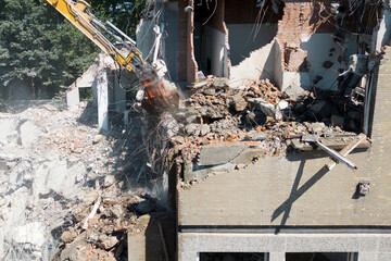 Aerial view of buildings being demolished by heavy machinery