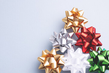 Close-up of elegant Christmas ornaments on a blue-grey background. Shiny metallic details with copy space for holiday greetings or designs.