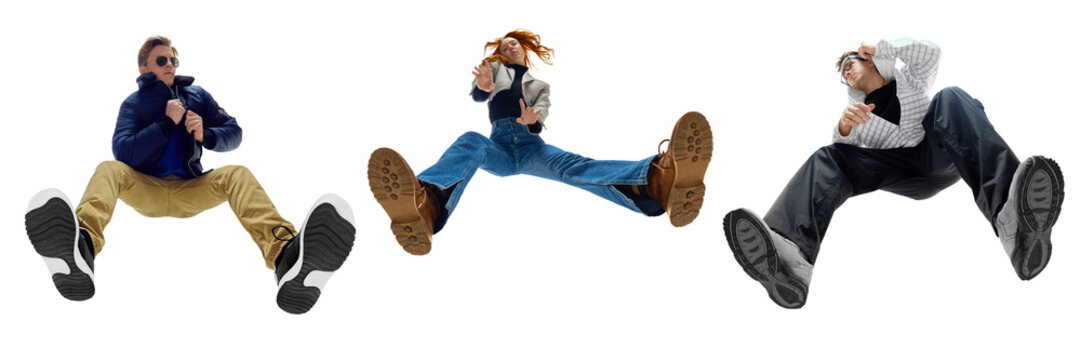 Three trendy young people in stylish casual clothes posing in dynamic pose posing against white background. Bottom view. Concept of fashion, youth culture, lifestyle, casual wear. Banner. Collage