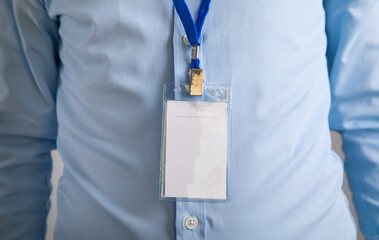 Businessman showing a plastic empty badge.
