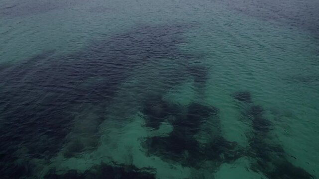 This aerial video captures the stunning beauty of Haukland Beach, located on the Lofoten Islands in Norway. The beach is known for its crystal-clear turquoise waters, pristine white sands, and dramati