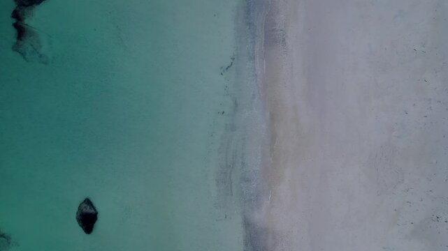 This aerial video captures the stunning beauty of Haukland Beach, located on the Lofoten Islands in Norway. The beach is known for its crystal-clear turquoise waters, pristine white sands, and dramati